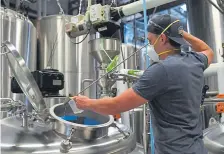  ?? RJ Sangosti, The Denver Post ?? Assistant brewer Josh Strobel helps to brew a pale ale called Colorado Strong at Red Truck Beer Co. in Fort Collins on Tuesday.