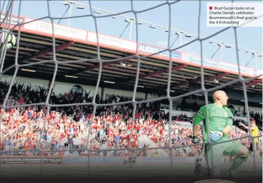  ??  ?? Brad Guzan looks on as Charlie Daniels celebrates Bournemout­h’s final goal in the 4-0 thrashing