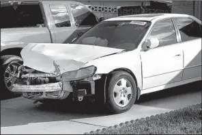  ?? AP/KEN RITTER ?? Karina Dorado’s white Honda Accord, damaged in a wreck in March, is parked in a driveway in Las Vegas on Tuesday. Dorado was injured when the salvaged airbag in the car exploded during the wreck.