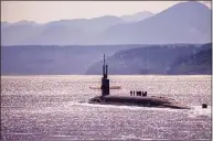  ?? Lt.Cmdr. Michael Smith / Commander, Submarine Group Nine ?? The Ohio-class ballistic missile submarine USS Louisiana transits Puget Sound in 2018. The Department of Defense is requesting $2.4 billion to help Electric Boat, Newport News Shipbuildi­ng and their suppliers train workers to build the new Columbia class of ballistic missile subs, as well as attack subs.