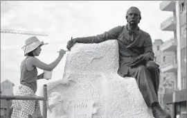  ??  ?? AN ARTIST works on a sculpture of Cuban poet J. C. Zenea in Havana. Obama will meet President Raul Castro but not with his brother Fidel Castro.