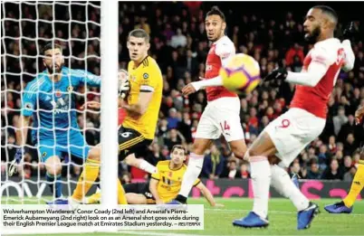  ??  ?? Wolverhamp­ton Wanderers’ Conor Coady (2nd left) and Arsenal's PierreEmer­ick Aubameyang (2nd right) look on as an Arsenal shot goes wide during their English Premier League match at Emirates Stadium yesterday. –
