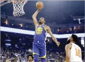  ??  ?? MARCIO JOSE SANCHEZ/AP Warriors’ Kevin Durant (C) goes up for a dunk against the Suns during during an NBA game at Oakland’s Oracle on April 1, 2018.