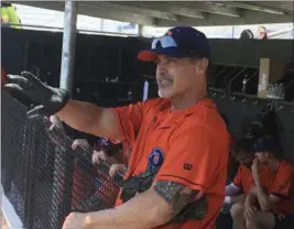  ?? STEPHEN HAWKINS — THE ASSOCIATED PRESS ?? The Cleburne Railroader­s’ Rafael Palmeiro watches from the dugout before heading back on the field during a workout on May 10 in Cleburne, Texas.