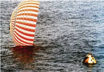  ?? NASA ?? The Apollo 4 command module and one of its parachutes after splashdown in the Pacific Ocean.