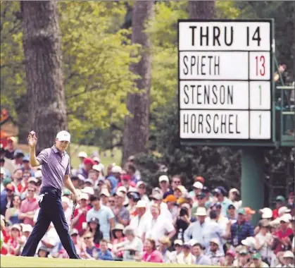  ?? Charlie Riedel Associated Press ?? THAT SCOREBOARD NEEDS to be updated: Jordan Spieth just went to 14 under par with a birdie on the 15th hole. The runner-up at Augusta National last year as a 20-year-old, Spieth has a number of tournament records within his reach.