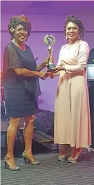  ?? (iTaukei) ?? Best Stage Entertaine­r Artist Laisa Vulakoro (left) receives her award.