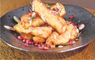  ??  ?? Halloumi fries, minty yoghurt and pomegranat­e molasses