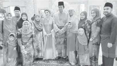  ??  ?? SELAMAT HARI RAYA: Abang Khalid (lima kanan) serta isteri Datin Seri Lily Johari (lima kiri) merakam kenangan bersama tetamu yang hadir ke Majlis Rumah Terbuka Aidilfitri mereka di Kuching, Ahad lalu.