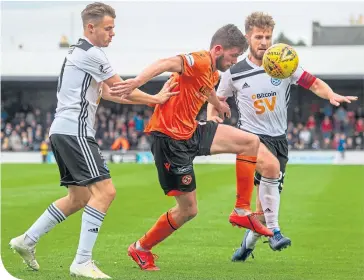  ??  ?? Dundee United’s Sam Stanton holds off Ayr’s Alan Forrest and Ross Docherty