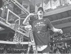  ?? ZACH BOYDEN-HOLMES/THE REGISTER / USA TODAY NETWORK ?? Iowa guard Caitlin Clark cuts down the net after beating LSU in the Elite 8 round of the NCAA women's tournament against LSU on April 1 in Albany, N.Y.