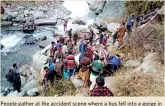  ?? (AFP) ?? People gather at the accident scene where a bus fell into a gorge in Poonch, in Jammu and Kashmir on Saturday