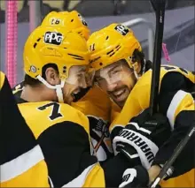  ?? Peter Diana/Post-Gazette ?? Frederick Gaudreau, right, has helped stabilize the depth at center over the past few injury-plagued weeks for the Penguins. Here, he celebrates a goal against the Islanders Saturday night.