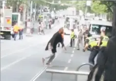  ??  ?? This handout video grab via the Instagram account of Chris Newport shows a man fighting with policemen in downtown Melbourne after he stabbed a number of people.