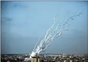  ?? KHALIL HAMRA / ASSOCIATED PRESS ?? Rockets are launched from the Gaza Strip towards Israel, Monday.