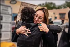  ?? NATHAN BURTON/Taos News file photo ?? A business owner embraces demonstrat­ors during a rally for reproducti­ve rights in downtown Taos following the Dobbs v. Jackson decision in 2022.