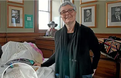  ?? ELEANOR WENMAN/STUFF ?? Vinnies Re Sew textile recycling co-ordinator Caroline O’Reilly with some of the completed panels for the Suffrage in Stitches project taking place at Wellington Museum.