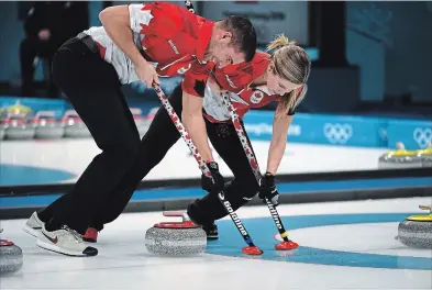  ?? NEW YORK TIMES FILE PHOTO ?? Canadians John Morris and Kaitlyn Lawes are pictured in action on their way to the first gold medal in Olympic mixed doubles curling in February.