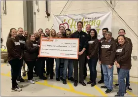  ?? COURTESY OF DUNKIN’ BRANDS ?? Representa­tives of area Dunkin’ coffee and doughnut shops present a check for $17,500 to Jay Worrall, president of Helping Harvest Food Bank in Spring Township. The food bank serves more than 100,000people in Berks and Schuylkill counties