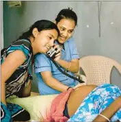  ?? Allison Joyce
Associated Press ?? IN ANAND, India, women listen to a baby’s heartbeat in a surrogate dormitory run by Akanksha clinic.