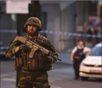  ?? GEERT VANDEN WIJNGAERT, THE ASSOCIATED PRESS ?? Police and soldiers patrol in front of Central Station in Brussels after a reported explosion on Tuesday. Only the suspected attacker was killed.