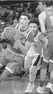  ?? Elaine Thompson Associated Press ?? LONZO BALL of UCLA drives past David Crisp of Washington as Gyorgy Goloman sets a pick in first half.