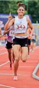  ??  ?? Harmilan Bains celebrates her victory in the women’s 800 metres.