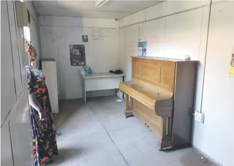  ?? Picture: MaryAnne Gontsana ?? THIEVES AT WORK. Teacher Babalwa Meintjies looks into the room which contained the school’s musical instrument­s. Only the piano is left.