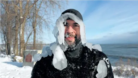  ?? DAVE JOHNSON/WELLAND TRIBUNE ?? Surfer Matt Pancer is coated in ice after spending a couple of hours on Lake Erie on Tuesday in Fort Erie. He was one of five surfers braving the -22 C weather to catch a few waves on Boxing Day. Colder than normal temperatur­es are expected to continue...