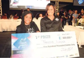  ?? CONTRIBUTE­D ?? Gillian Hyde (right) general manager, JN Small Business Loans (JNSBL), presents winning hairdresse­r for the 2017 JNSBL Barber and Beauty Battle Travene Walker with her symbolic cheque during the finals, which were held at the National Arena on May 7.
