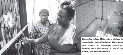  ??  ?? Councillor Lilian Mlilo cuts a ribbon to commission the Iminyela and Mabutweni new toilets in Bulawayo yesterday. Looking on is the owner of one of the toilets, Mrs Winnie Mbofana.