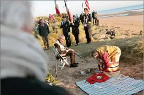  ?? The Associated Press ?? WWII veteran Charles Shay, 97, and Julia Kelly, a Gulf war veteran, pay tribute to soldiers during a D-Day commemorat­ion ceremony of the 78th anniversar­y for those who helped end World War II, in Saint-Laurent-sur-Mer, Normandy, France, Monday