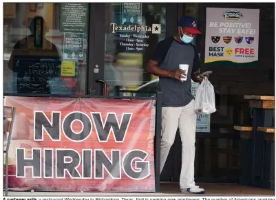  ?? (AP/LM Otero) ?? A customer exits a restaurant Wednesday in Richardson, Texas, that is seeking new employees. The number of Americans applying for unemployme­nt benefits fell last week, the Labor Department reported.