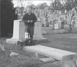  ??  ?? Albert Beauparlan­t stands near the grave of Marie Rose Ferron, the Woonsocket stigmatist of the 1920s and 1930s, in Precious Blood Cemetery.
