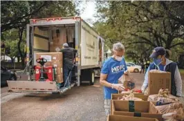  ?? SERGIO FLORES NYT FILE ?? Food is prepared for clients at a pantry in Houston. The Supreme Court has dismissed an appeal from states to step in to defend the Trump-era “public charge” rule.