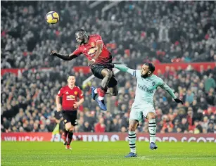  ?? Picture: MICHAEL REGAN/GETTY IMAGES ?? TURNING HEADS: Airborne Eric Bailly of Manchester United battles for possession with Alexandre Lacazette of Arsenal during their Premier League clash at Old Trafford in Manchester on Wednesday.