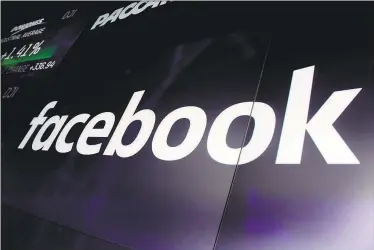  ?? Associated Press file photo ?? Facebook’s logo appears on screens at the Nasdaq MarketSite in New York’s Times Square in March. Facebook said Friday that it will flag all “newsworthy” posts from politician­s that break its rules, including those from President Donald Trump.