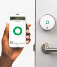  ?? August Home ?? August Home’s app, left, works its connected door locks like the one at right, which shows it is open.