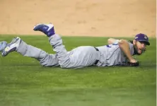  ?? Tom Pennington / Getty Images ?? Dodgers pitcher Clayton Kershaw ends up on the ground in the sixth inning. He was KO’d before the sixrun frame ended.