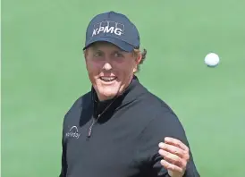  ?? ROB SCHUMACHER/AZCENTRAL SPORTS ?? Phil Mickelson reacts after an eagle on the second hole during the first round of the Masters at Augusta National Golf Club. Mickelson shot a 1-under 71 on Thursday.