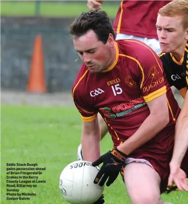  ??  ?? Eddie Stack Duagh gains possession ahead of Brian Fitzgerald Dr Crokes in the Kerry County League at Lewis Road, Killarney on Sunday
Photo by Michelle Cooper Galvin