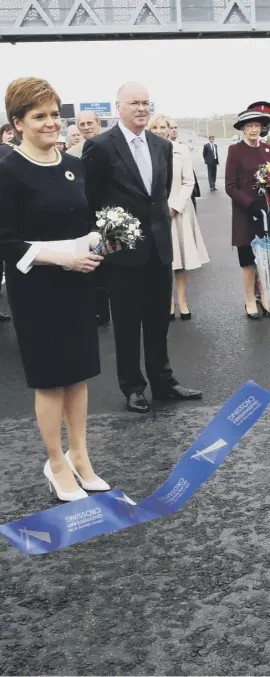  ??  ?? 0 The Queen cuts the ribbon to officially open the new Queensferr­y Crossing, praising the three bridges that span the Forth, linking Fife and the Lothians