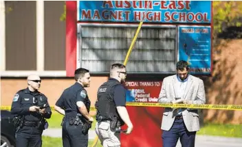  ?? SAUL YOUNG KNOXVILLE NEWS SENTINEL VIA AP ?? Law enforcemen­t officers respond to a shooting Monday at Austin-East Magnet High School in Knoxville, Tenn. Authoritie­s say a student was shot and killed and an officer was hospitaliz­ed with serious injuries.