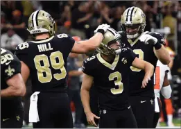  ?? AP PHOTO / BILL FEIG ?? New Orleans Saints kicker Wil Lutz (3) is congratula­ted by tight end Josh Hill after kicking the game winning field goal during the second half of an NFL football game in New Orleans against the Cleveland Browns, Sunday.