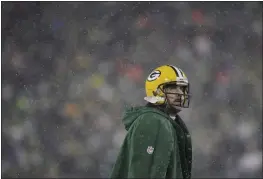  ?? AARON GASH — THE ASSOCIATED PRESS ?? The Green Bay Packers’ Aaron Rodgers looks up during the second half of an NFC divisional playoff game against the San Francisco 49ers on Saturday in Green Bay, Wis.