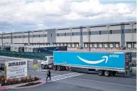  ?? AP Photo/eduardo Munoz Alvarez, File ?? ■ A truck arrives at the Amazon warehouse facility April 1 in the Staten Island borough of New York. Amazon will hire 150,000 full-time, part-time and seasonal employees across its warehouses ahead of the holiday season. The announceme­nt, made Thursday, shows the e-commerce behemoth is taking a less conservati­ve approach to its holiday planning than Walmart.