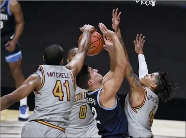  ?? JESSICA HILL — THE ASSOCIATED PRESS ?? Boston College’s Steffon Mitchell, left, stops a shot attempt by Villanova’s Collin Gillespie as Boston College’s Frederick Scott, back, and Makai Ashton-Langford right, defend during the first half of an NCAA college basketball game Wednesday.