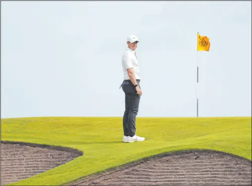  ?? Peter Morrison The Associated Press ?? Rory Mcilroy surveys the scene on the 10th green at Royal St. George’s during the first round of the British Open.