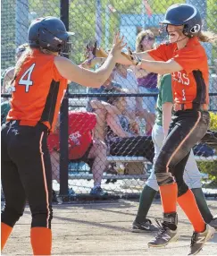  ?? STAFF PHOTOS BY CHRIS CHRISTO ?? NO TAMING TIGERS: Newton North’s Caroline Bass (above right) scores the winning run and celebrates with Emma Arpino, and Kira Flegenheim­er (below left) slides in with the tying run in yesterday’s 2-1 against Billerica at Endicott.