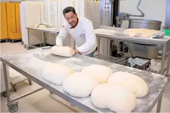  ?? ?? Exner kneads bread dough at his bakery in Beelitz.